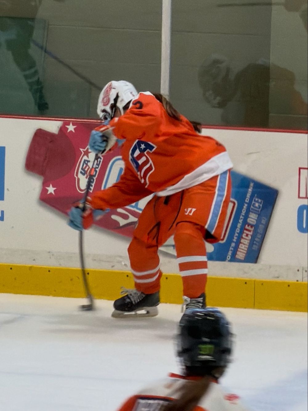 Cameron Cadena moving the puck along the boards at the Girls National 15 Camp